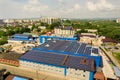 Aerial view of many photo voltaic solar panels mounted of industrial building roof Royalty Free Stock Photo