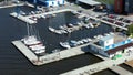 Aerial view of many white yachts and speed boats at harbor. Video. Sailing boats moored at the port in a city pond near