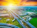 Aerial view of a massive highway intersection, Highway to city transport traffic road with vehicle movement at sunset. Royalty Free Stock Photo