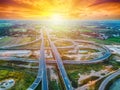 Aerial view of a massive highway intersection, Highway to city transport traffic road with vehicle movement at sunset, Rural Royalty Free Stock Photo