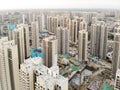 Aerial view of massive identical buildings site in construction with tower crane.