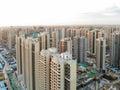 Aerial view of massive identical buildings site in construction with tower crane.