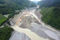 aerial view of massive landslide that has blocked a river, creating temporary lake