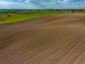 Aerial view of meadows and agricultural field in spring with blue sky, Mazury