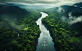 Aerial View of a Meandering River Flowing Through a Dense Green Rainforest with Misty Atmosphere and Lush Foliage Royalty Free Stock Photo
