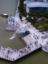 Aerial view of Merlion with crowded tourists. The icon of Singapore with tall skyscrapers on the background