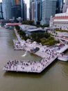 Aerial view of Merlion with crowded tourists. The icon of Singapore with tall skyscrapers on the background Royalty Free Stock Photo