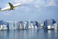 Airplane flying over Miami skyscrapers