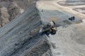 Aerial view of the mine waste dumping process using mining trucks Royalty Free Stock Photo