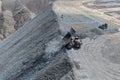 Aerial view of the mine waste dumping process using mining trucks Royalty Free Stock Photo