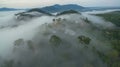 Aerial view mist above the mountain in tropical rainforest and .beautiful sunrise Royalty Free Stock Photo