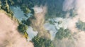 Aerial view of misty rainforest lakes in shape of world continents.