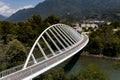 Aerial view of a modern arch shaped design pedestrian bridge over the Ticino river in Switzerland