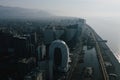 Aerial view of modern Batumi city skyline against a mountain backdrop, illuminated by the morning sun, reflecting off Royalty Free Stock Photo