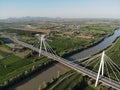 Aerial view of a modern bridge over a river in northern Italy. Royalty Free Stock Photo