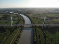 Aerial view of a modern bridge over a river in northern Italy. Royalty Free Stock Photo