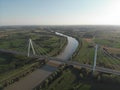 Aerial view of a modern bridge over a river in northern Italy. Royalty Free Stock Photo