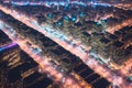 Aerial view of modern city at night, skyscrapers and street lights. Generative AI