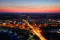 Aerial view of modern European city outskirts in evening lights Royalty Free Stock Photo