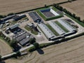 Aerial view of modern farm yard showing neat buildings and surrounded by ploughed fields