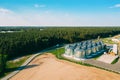 Aerial View Modern Granary, Grain-drying Complex, Commercial Grain Or Seed Silos In Sunny Spring Rural Landscape. Corn Royalty Free Stock Photo