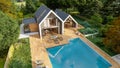 Aerial view of Modern pitched roof villa with pool and garden Royalty Free Stock Photo