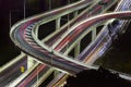 Aerial view of modern urban traffic road at night. Cityscape overpass with light trails. Royalty Free Stock Photo