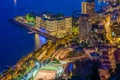 Aerial view of Monaco - Monte-Carlo at dusk, cityscape with night illumination, mountain, skyscrapers, mediterranean sea Royalty Free Stock Photo