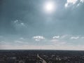 Aerial view on moody city streets with sun in sky