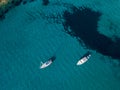 Aerial view of moored boats floating on a transparent sea. Corsica. France