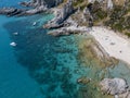 Aerial view of moored boats floating on a transparent sea. Scuba diving and summer holidays. Capo Vaticano, Calabria, Italy