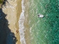 Aerial view of a moored dinghy floating on a transparent sea. Coastline, Corfu, Greece Royalty Free Stock Photo