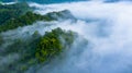 Aerial view of morning mist at tropical rainforest mountain, background of forest and mist, Aerial top view background forest