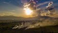 Aerial view. The morning sunrises with dry grass is burning on the field.