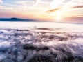 Aerial view of morning town covered by mist, sunrise