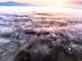 Aerial view of morning town covered by mist, sunrise