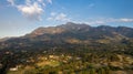 Aerial shot of a rural area with houses. land and mountains in the distance in Morogoro, Tanzania Royalty Free Stock Photo