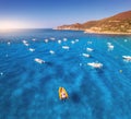 Aerial view of motorboats on blue sea at sunset in summer