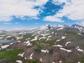 Aerial view mountain covered with snow over blue sky. Drone view mountain valley. Beautiful view from above surface of mountain Royalty Free Stock Photo