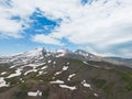 Aerial view mountain covered with snow over blue sky. Drone view mountain valley. Beautiful view from above surface of mountain Royalty Free Stock Photo