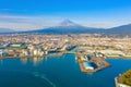 Aerial view of Mountain Fuji near industrial area, factory, Japanese port and harbour in Shizuoka City at sunset, Japan. Natural