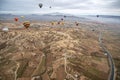 Colorful hot air balloons floating over mountain landscape with road in Cappadocia Turkey Royalty Free Stock Photo