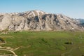 Aerial view of mountain meeting meadow with many paths