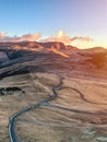 Aerial view of mountain road and beautiful orange sunrise in autumn. Top view of mountain landscape Royalty Free Stock Photo