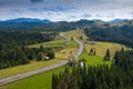 Aerial view of a mountain road in Bucovina Romania withe amazing forest landscape next to it Royalty Free Stock Photo