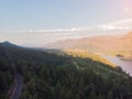 Aerial view of mountain road at clean blue sky background. The slopes with green trees. Beautiful landscape with hills and forest Royalty Free Stock Photo