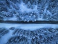 Aerial view of mountain road in fairy forest in snow in winter Royalty Free Stock Photo