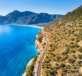 Aerial view of mountain road near blue sea, sandy beach at sunset Royalty Free Stock Photo