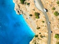 Aerial view of mountain road near blue sea, sandy beach at sunset Royalty Free Stock Photo