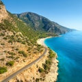 Aerial view of mountain road near blue sea, sandy beach at sunset Royalty Free Stock Photo